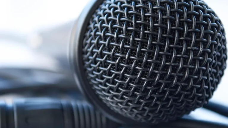 Microphone and headphones in a padded recording booth, the dubbing side of the subbing vs dubbing choice.