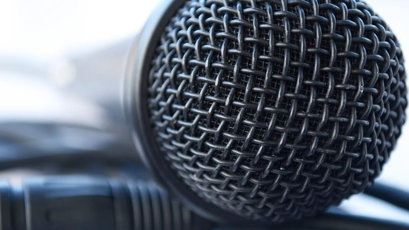 Microphone and headphones in a padded recording booth, the dubbing side of the subbing vs dubbing choice.